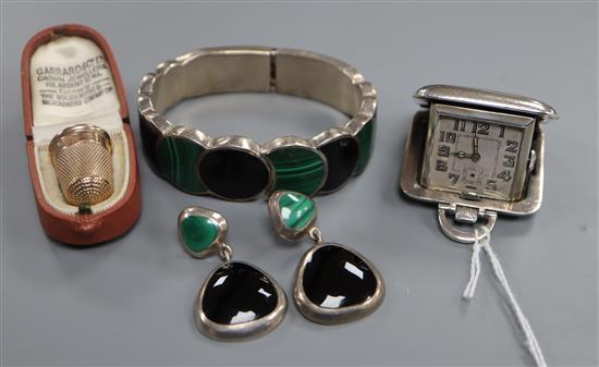 A late Victorian 9ct gold thimble in Garrard & Co leather case, a silver travelling watch and bangle and earring set